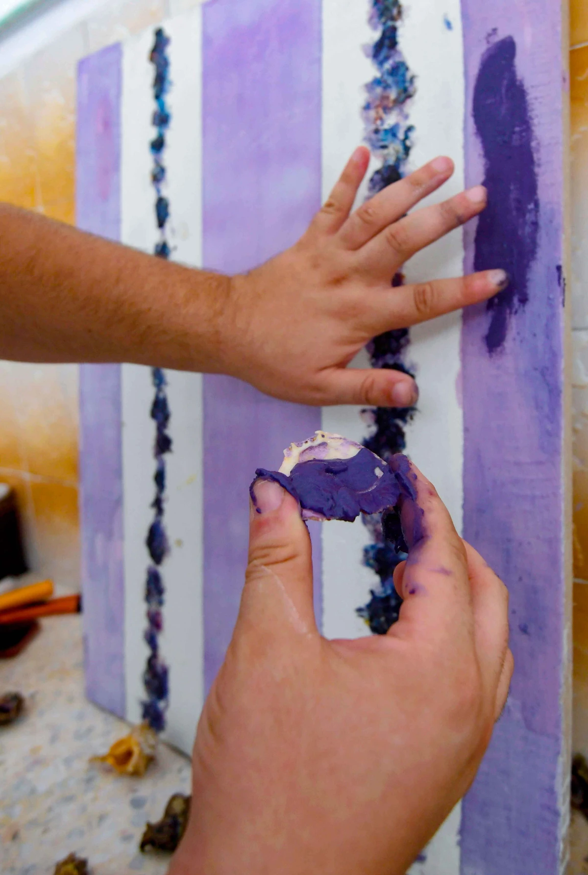 Tunisian craftsman Mohamed Ghassen Nouira tests a purple dye he extracted from Murex shells at his workshop in the capital Tunis. (AFP)