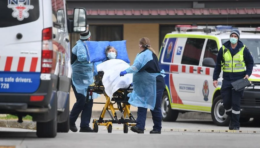 Ambulance officers remove a resident from the St Basil's Home for the Aged in the Melbourne suburb of Fawkner on July 27, 2020, with 84 cases of the COVID-19 coronavirus linked to the facility. (File/AFP)