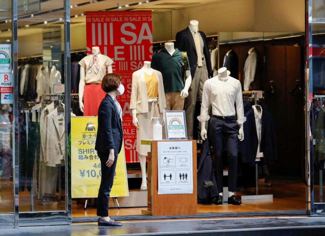 A woman wearing a protective face mask is seen at a shop selling office wear for men and women amid the coronavirus disease (COVID-19) outbreak in Tokyo, Japan July 26, 2020. (Reuters)