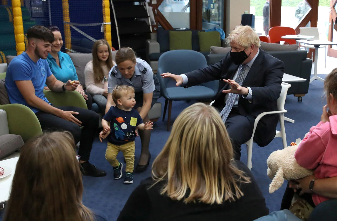 UK PM Boris Johnson meets with families in the community center at RAF Lossiemouth, during a visit to the Highlands and Northern Isles of Scotland, in Moray, Scotland, Britain, July 23, 2020. (Reuters)