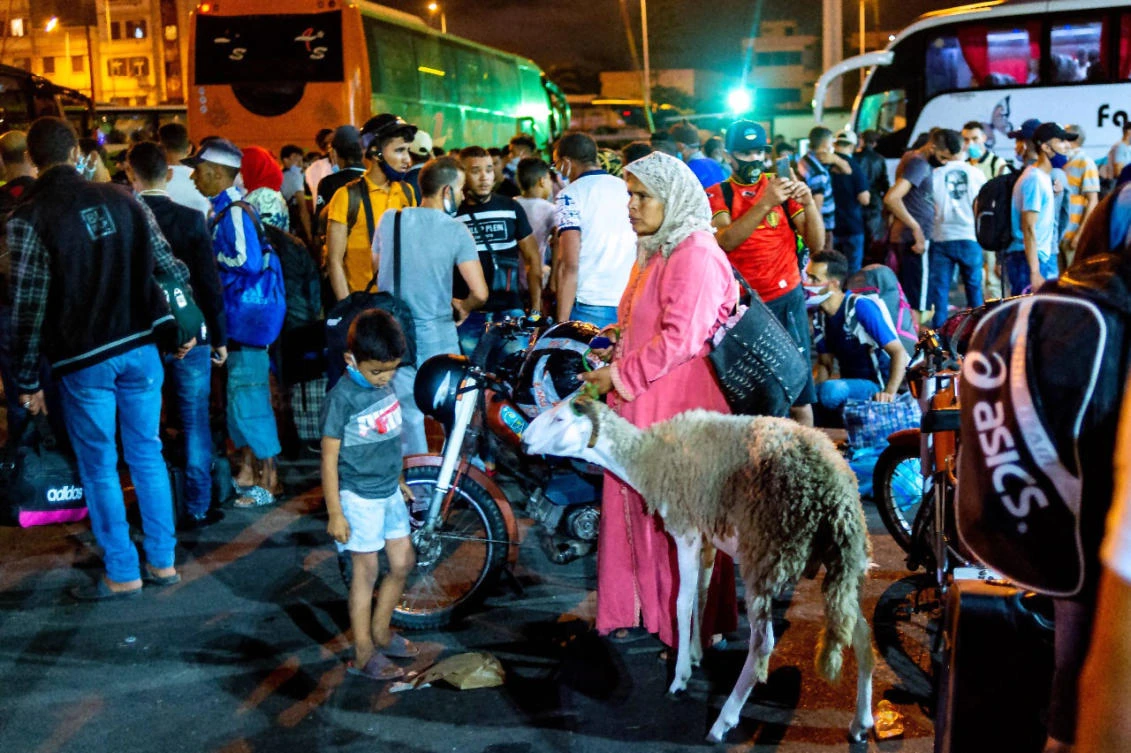 Moroccans gather in the "Ouled Ziane" bus station in Casablanca on July 26 ,2020 to leave the city before travel restrictions imposed by authorities to smother a new outbreak of the novel coronavirus. (AFP)