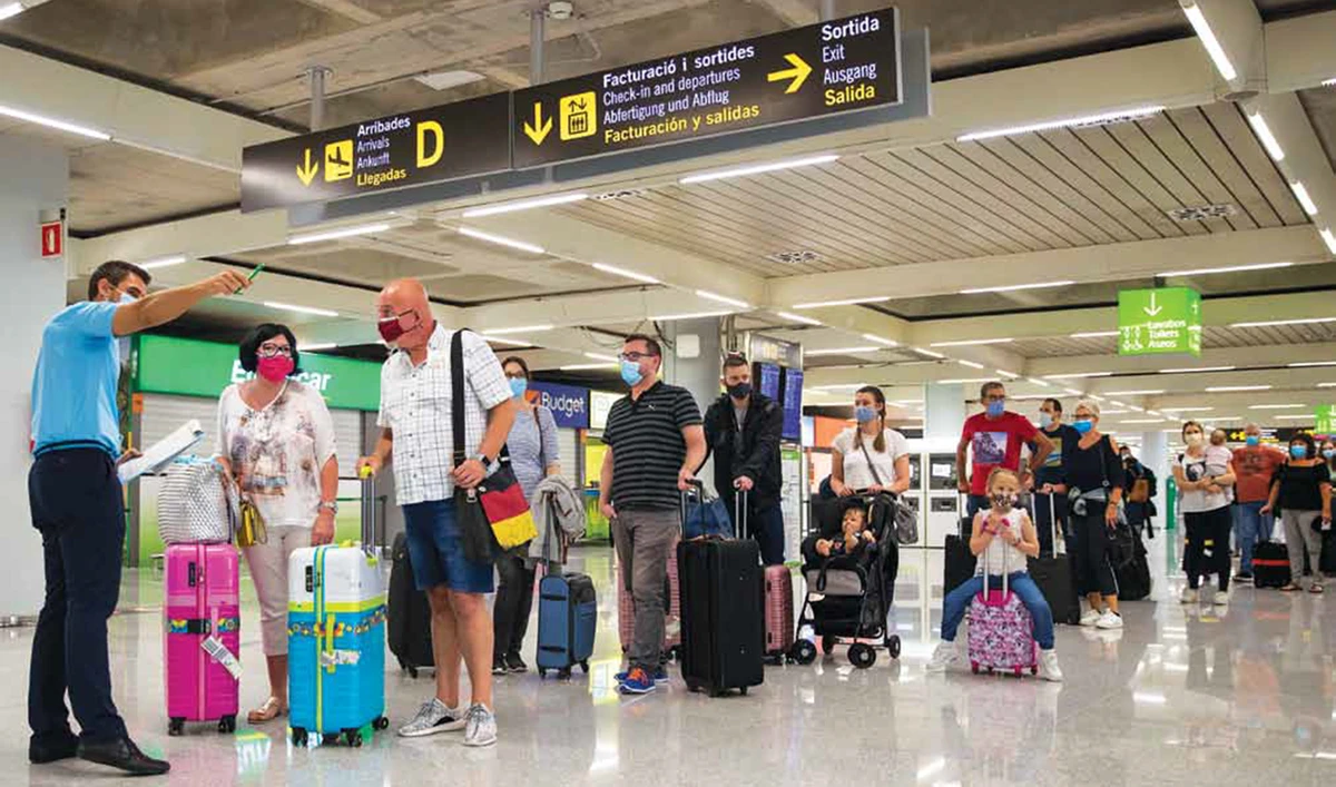 Tourists arrive at Son Sant Joan Airport in Palma de Mallorca following a national lockdown to stop the spread of the COVID-19 disease in Spain. (AFP)