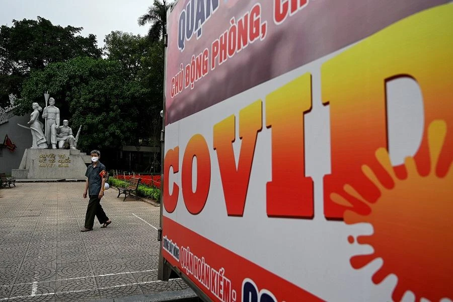 A man wearing a face mask walks past an empty open public area, amid Vietnam's nationwide social isolation effort as a preventive measure against the spread of the COVID-19 novel coronavirus, in Hanoi on April 22, 2020. (File/AFP)