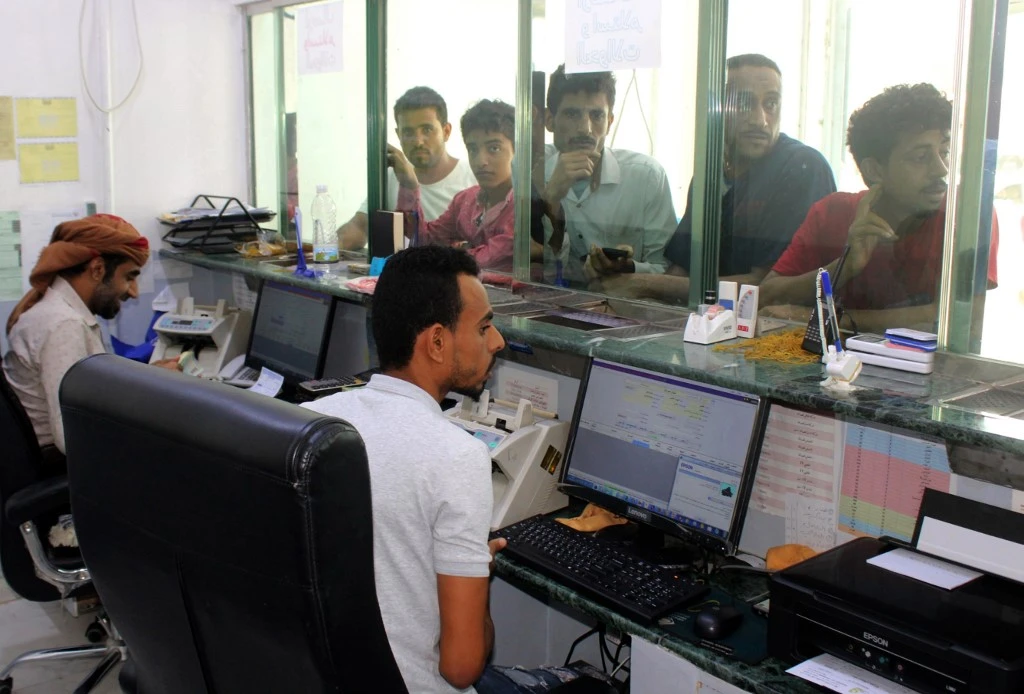 Yemeni men wait at a money exchange office in the southern port city of Aden on January 23, 2020. (File/AFP)