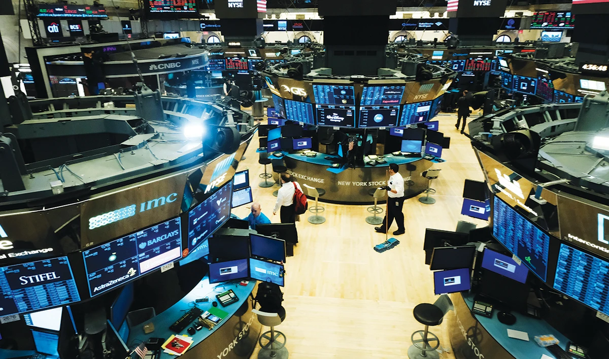 A view of the New York Stock Exchange. The dollar’s weakness would take at least a year to feed through to the US manufacturing sector. (AFP)