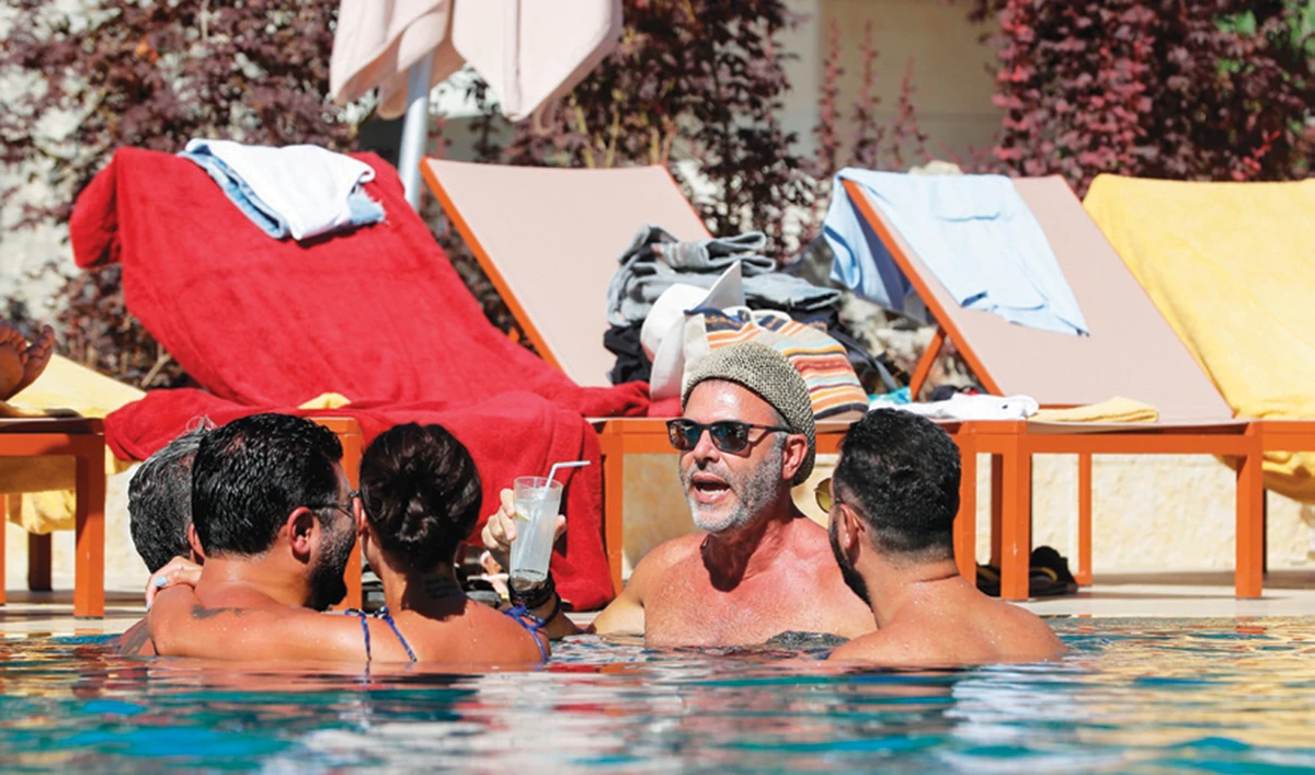 Lebanese holidaymakers gather at a swimming pool in the upmarket Faqra Club in the mountains north of Beirut. (AFP)
