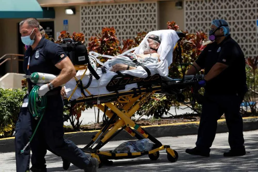 Emergency Medical Technicians (EMT) leave with a patient at Hialeah Hospital where COVID-19 patients are treated, in Hialeah, Florida, on July 29, 2020. (REUTERS/Marco Bello)
