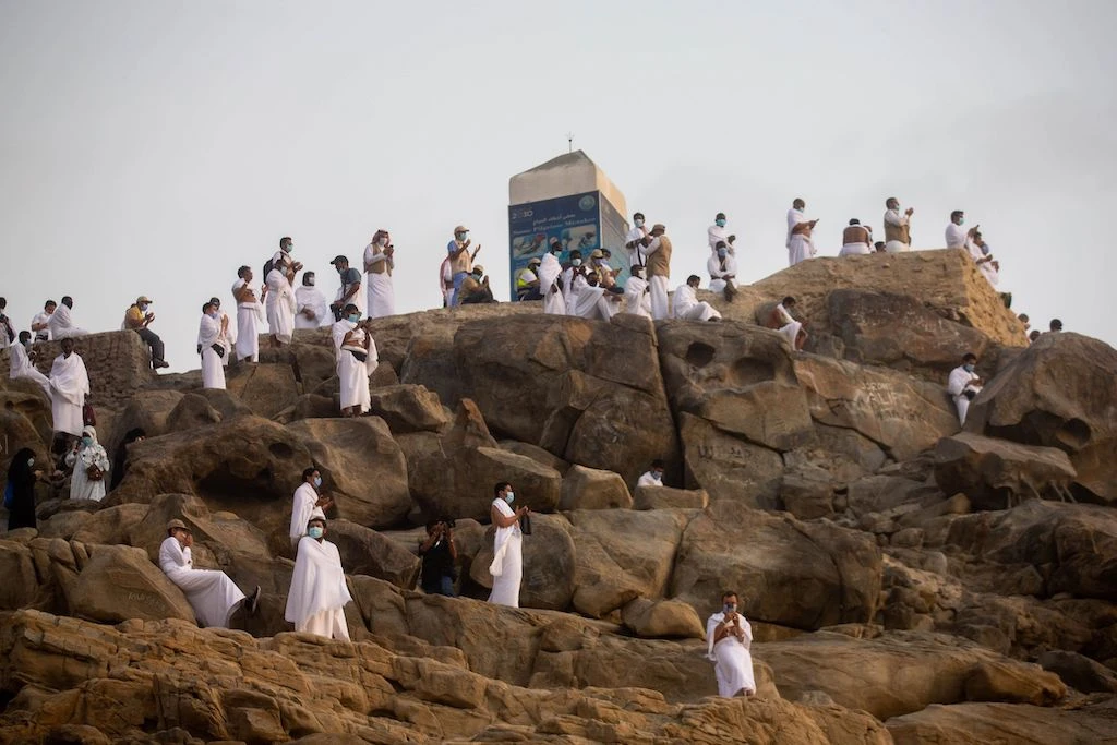 A handout picture provided by Saudi Ministry of Media on July 30, 2020 shows Mulism pilgrims praying on Mount Arafat, also known as Jabal al-Rahma (Mount of Mercy), southeast of the holy city of Mecca, during the climax of the Hajj pilgrimage amid the COVID-19 pandemic. (AFP)