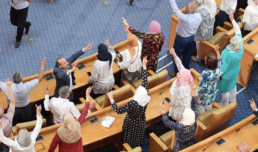 Deputies and members of the Tunisian Islamist Ennahda party rejoice following a plenary session at the parliament in the capital Tunis on July 30, 2020. (AFP)