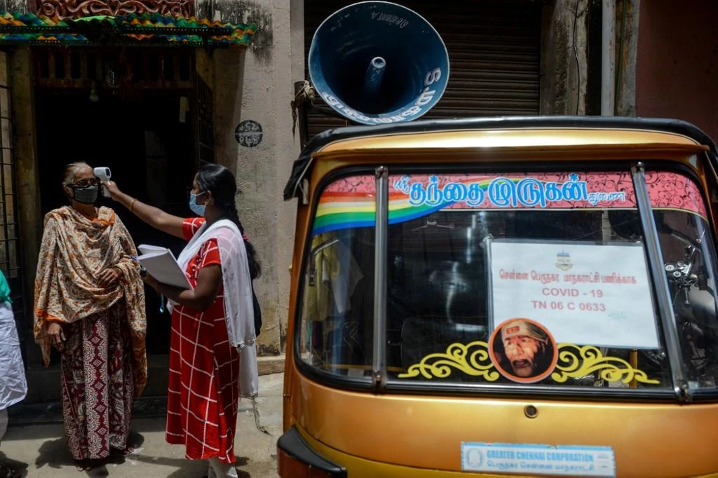 India aims to raise capacity to 1 million coronavirus tests per day in the medium term. Above, a health worker checks the temperature of a resident at a containment zone in Chennai on July 30, 2020. (AFP)