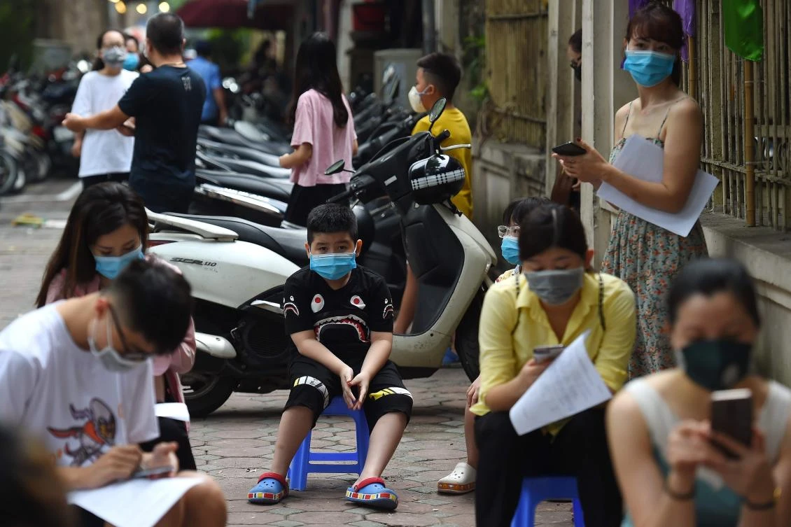 Residents wait to be tested at a makeshift rapid testing center in Hanoi as Vietnam recorded a rise in coronavirus cases on July 31, 2020. (AFP)