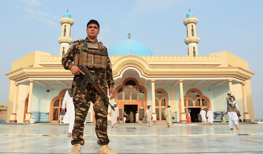 An Afghan security force stands guard outside a mosque before prayers during the Muslim festival of Eid al-Adha, amid the spread of the coronavirus disease (COVID-19), in Jalalabad, Afghanistan July 31, 2020. (REUTERS)