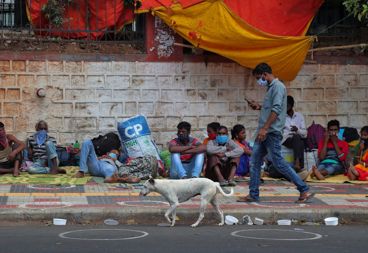 Migrant workers from other states rest on a pavement as they wait for trains to their home states in Hyderabad, India. (File/AP)