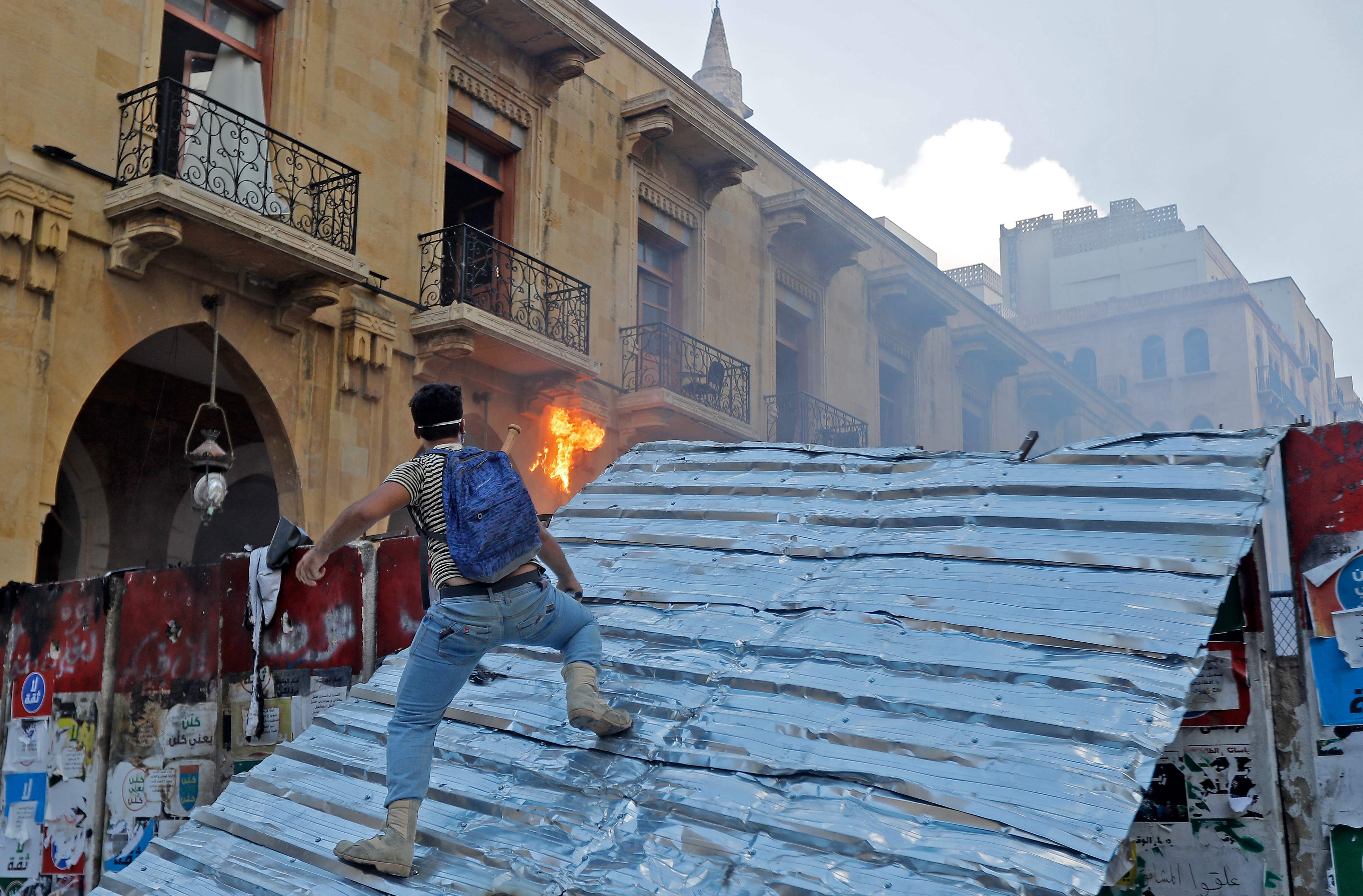 Protesters clash with police in Beirut as Lebanon's government resigns