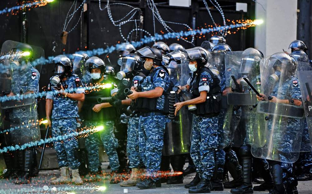Lebanese security forces clash with protesters near the parliament in central Beirut on August 10, 2020 following a huge chemical explosion that devastated large parts of the Lebanese capital. (AFP)