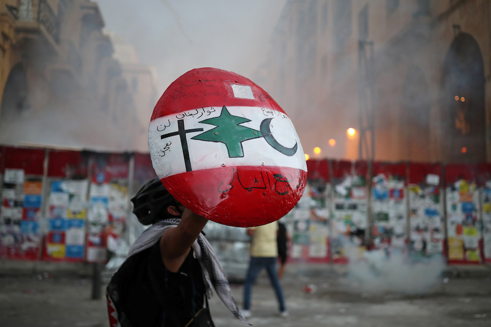 A demonstrator holds up a shield during anti-government protests that have been ignited by a massive explosion in Beirut, Lebanon August 10. (Reuters)