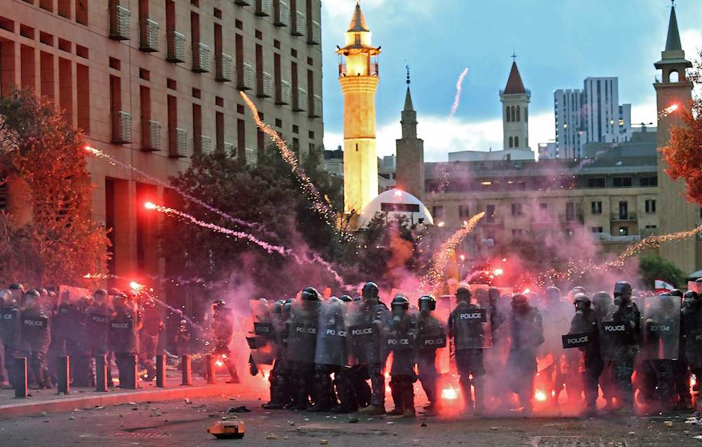 Lebanese security forces clash with protesters near the parliament in central Beirut on August 10, 2020 following a huge chemical explosion that devastated large parts of the Lebanese capital. (AFP)