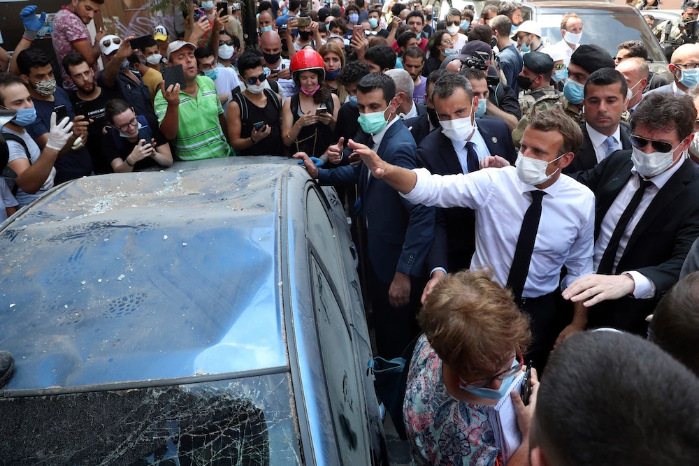 French President Emmanuel Macron visits the Gemayzeh neighborhood, which suffered extensive damage from an explosion on Tuesday that hit the seaport of Beirut, Lebanon, Thursday, Aug. 6, 2020. (AP)