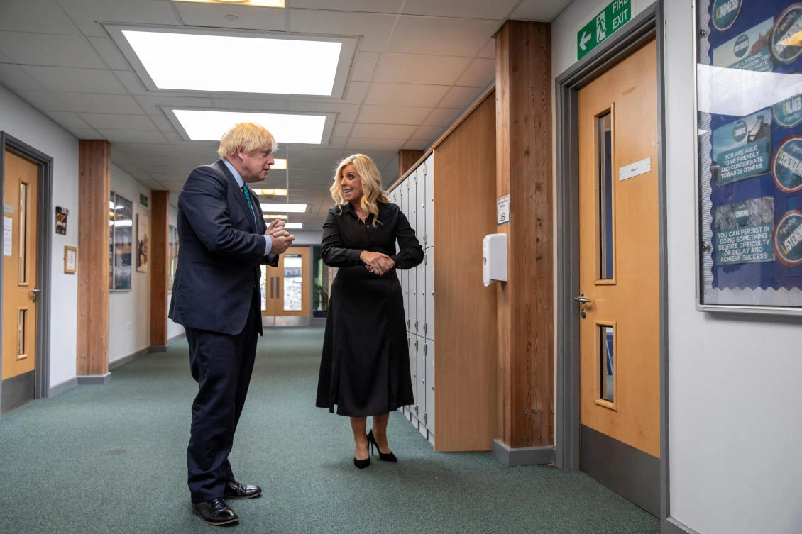 Britain's Prime Minister Boris Johnson speaks with school's CEO Julia Patrick as he visits Castle Rock school on the pupil's first day back to school, in Coalville, Britain August 26, 2020. Jack Hill/Pool via REUTERS