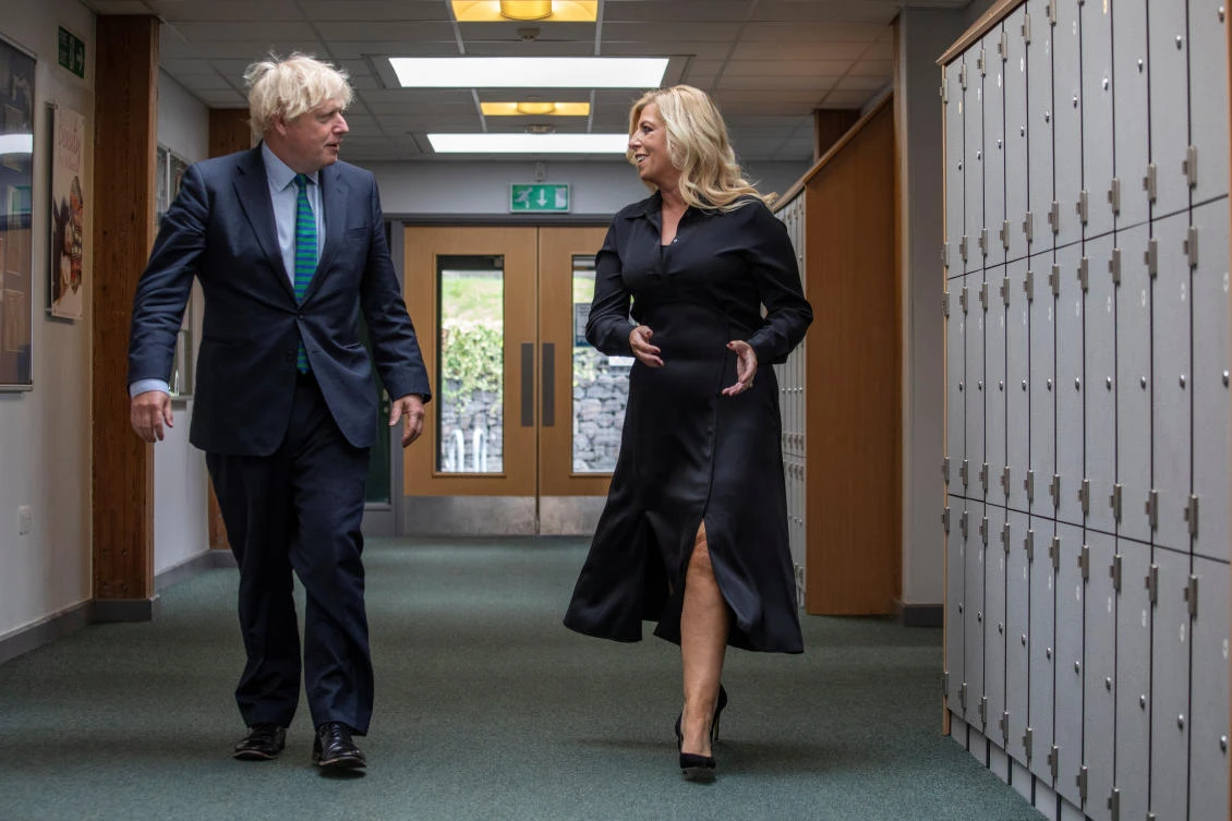 Britain's Prime Minister Boris Johnson speaks with school's CEO Julia Patrick as he visits Castle Rock school on the pupil's first day back to school, in Coalville, Britain August 26, 2020. Jack Hill/Pool via REUTERS