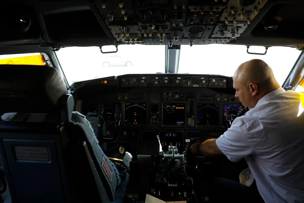 A member of the flight crew sits in the cockpit of Israeli flag carrier El Al’s Flight LY971 flight to the UAE. (AP)