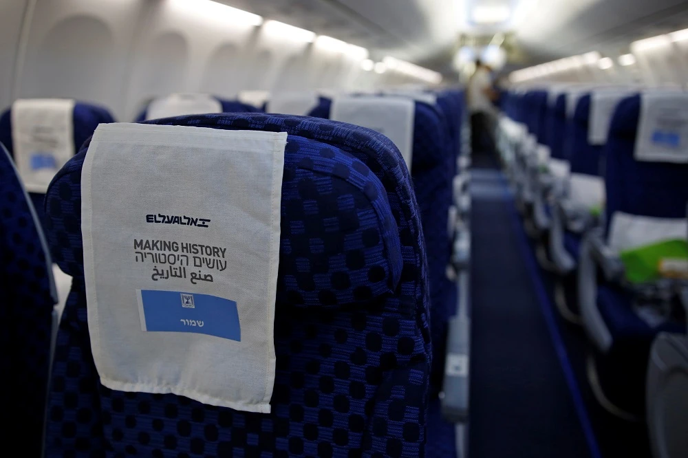 A seat cover reading in Arabic, English and Hebrew ‘making in history’ inside Israeli flag carrier El Al’s Flight LY971 to Abu Dhabi in the UAE. (Reuters)