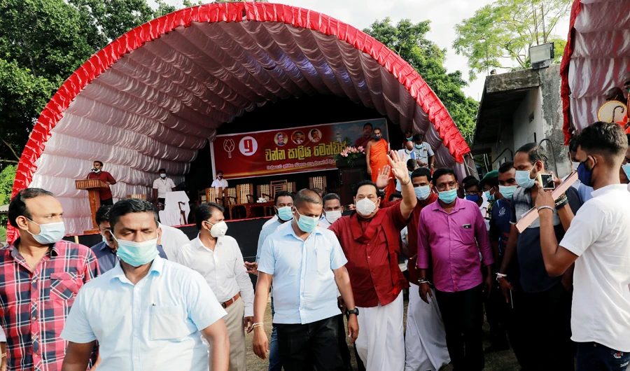 Leader of Sri Lanka People's Front party and Prime Minister Mahinda Rajapaksa, wearing a protective mask, waves at his supporters during a campaign rally ahead of country's parliamentary elections which are scheduled for August 5th 2020, in Ahungalla, Sri Lanka, August 1, 2020. (REUTERS)