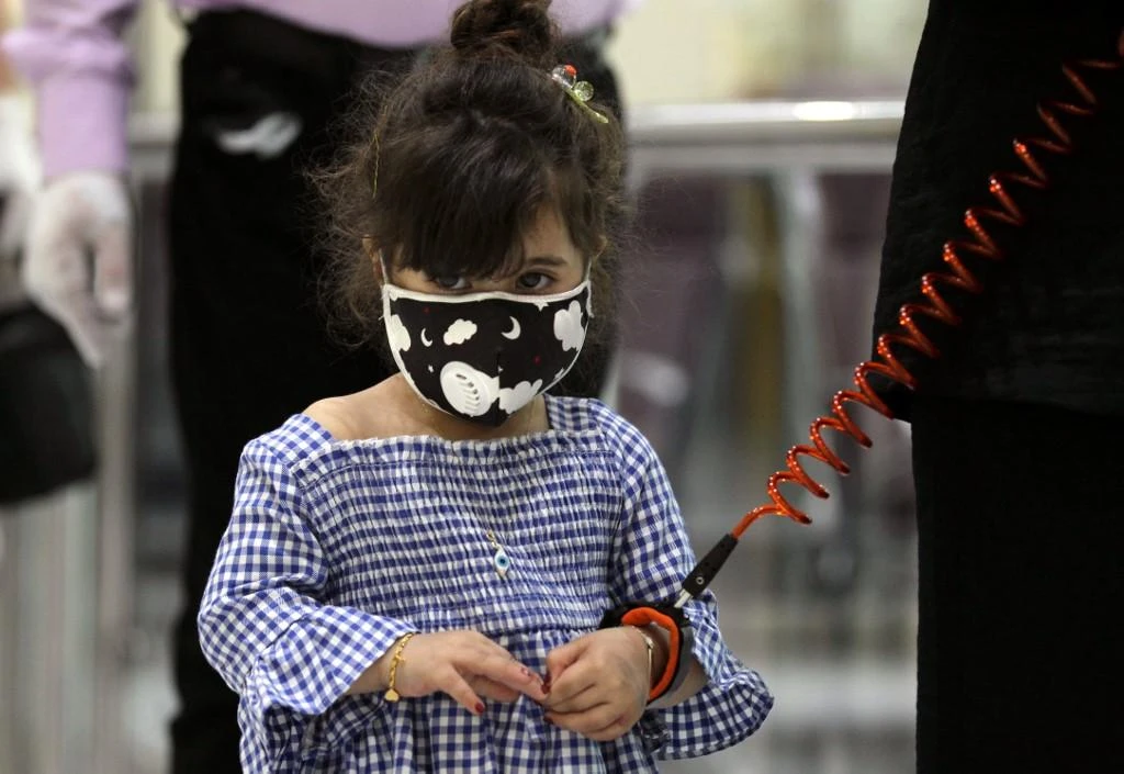 A girl waits to board a flight at the departure hall of Baghdad international airport. (File/AFP)