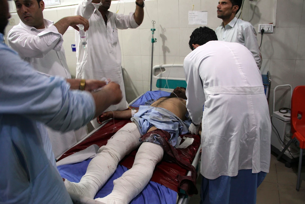 A wounded man receives treatment at a hospital after a suicide car bomb and multiple gunmen attack in the city of Jalalabad, east of Kabul, Afghanistan, Sunday, Aug. 2, 2020. (AP)