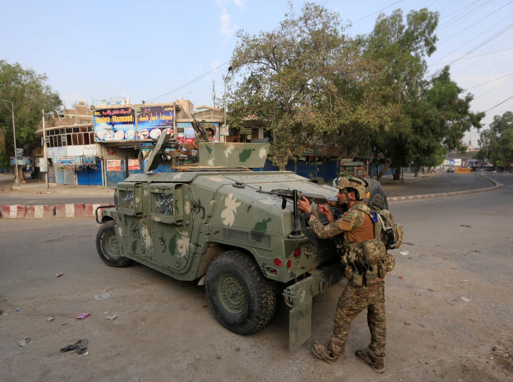 Afghan security forces keep watch near the site of an attack on a jail compound in Jalalabad on August 3, 2020. (Reuters)