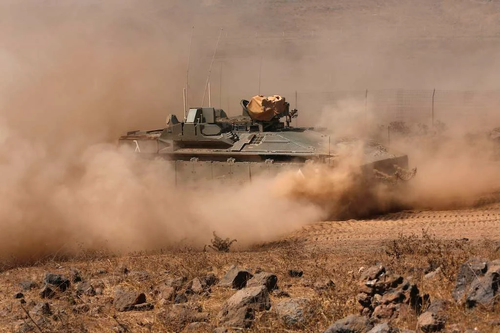 An Israeli army Namer IFV (Infantry Fighting Vehicle) drives during a drill in the Israeli-annexed Golan Heights, near the settlement of Merom Golan on the border with Syria, on August 3, 2020. (AFP)