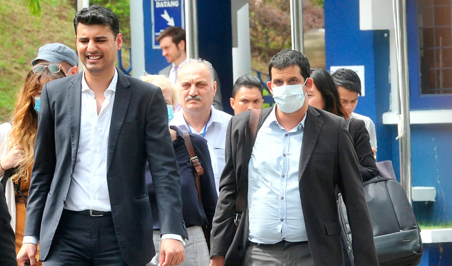 In this file photo taken on Friday, July 10, 2020, Australian Al Jazeera journalist, reporter/senior producer Drew Ambrose, right, leaves the Bukit Aman police headquarters after being questioned by the Malaysian police over a documentary about the country's arrests of undocumented migrants, in Kuala Lumpur, Malaysia. (AP)