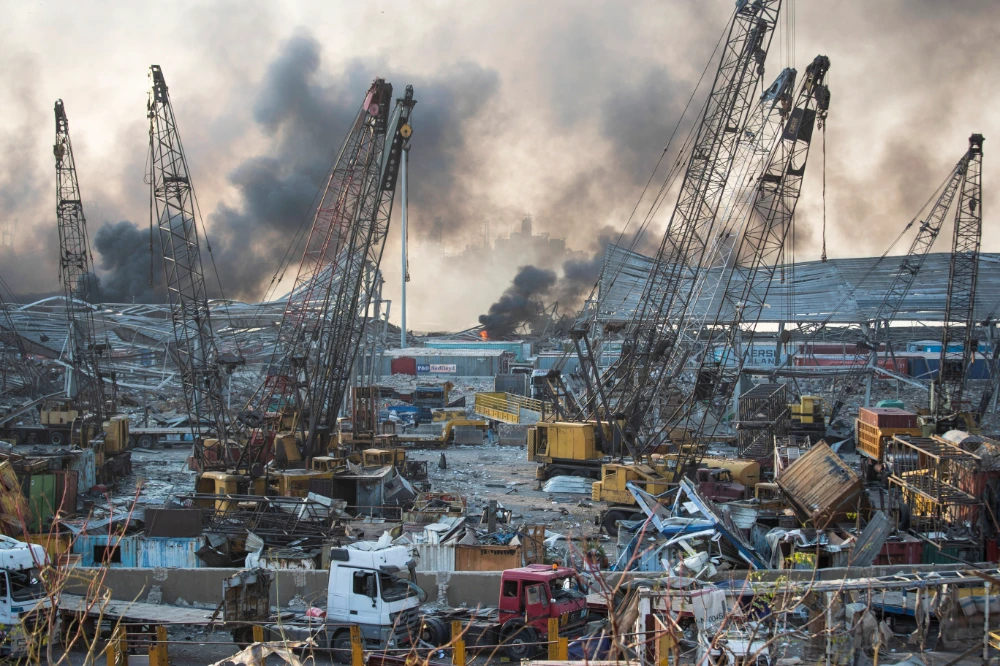 Smoke rises in the aftermath of a massive explosion in Beirut, Lebanon, on Aug. 4, 2020. (AP Photo/Hassan Ammar)