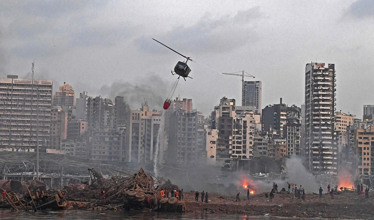 A helicopter try to put out multiple fires at the scene of the massive explosion that hit Beirut's port on Aug. 4, 2020 in the heart of the Lebanese capital. (AFP)