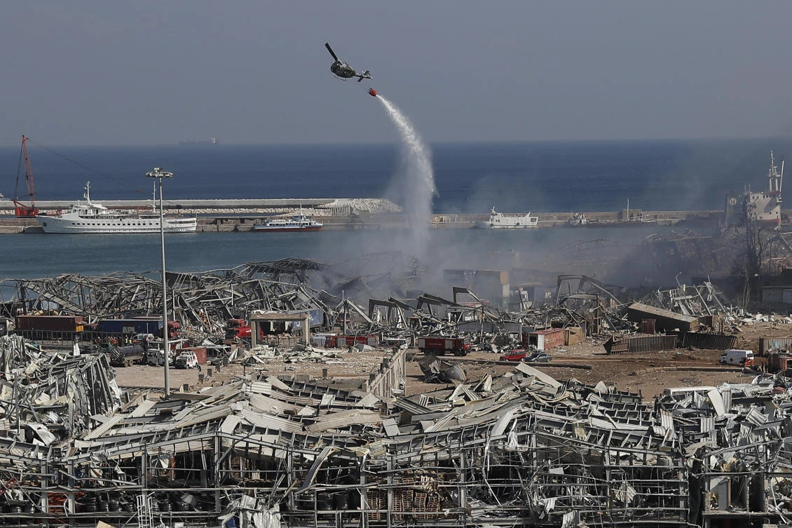 An army helicopter drops water at the scene of Tuesday's massive explosion that hit the seaport of Beirut, Lebanon, Wednesday, Aug. 5, 2020. (AP)