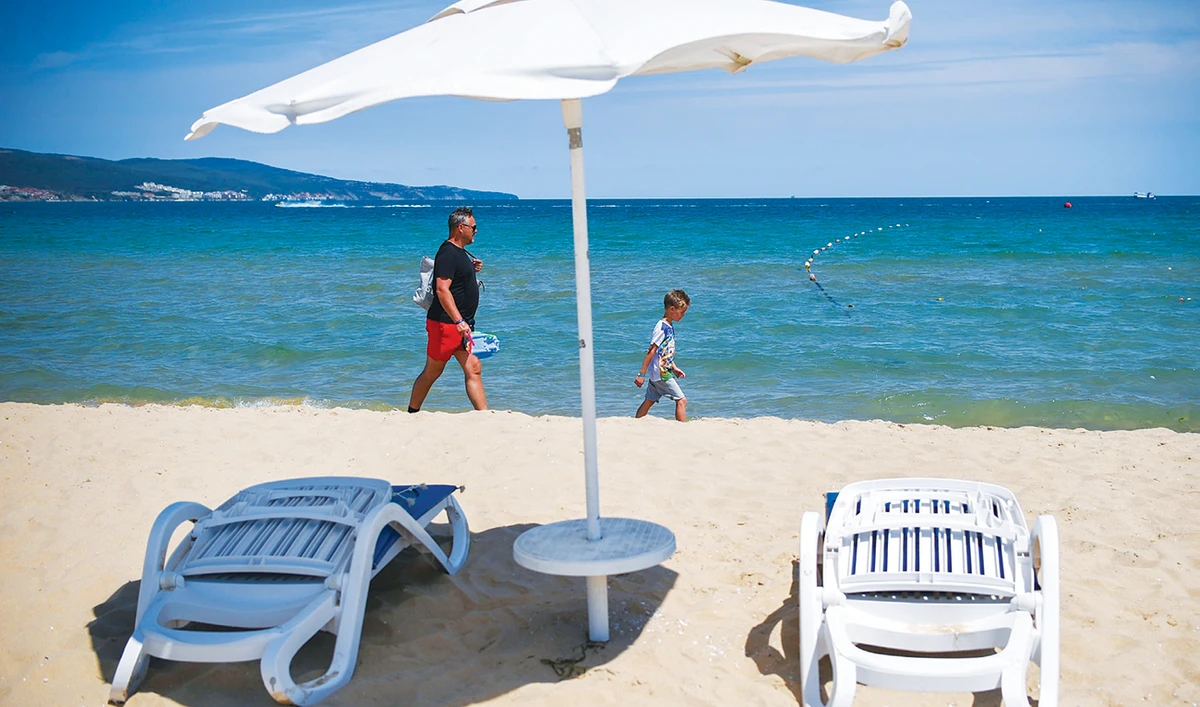 Tourists enjoy a walk in Sunny Beach, Bulgaria’s largest Black Sea resort. A spike in coronavirus has dealt a heavy blow to the country’s tourism industry. (AFP)