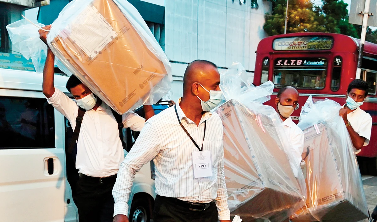 Election officials transfer ballot boxes to a main counting center after the parliamentary election voting centers closed in Colombo on Wednesday. (AFP)