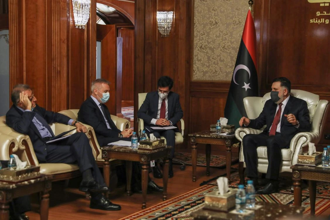 Prime Minister of Libya’s UN-recognized Government of National Accord Fayez Al-Sarraj (R) meets with Italian Minister of Defense Lorenzo Guerrini (2nd L) in the capital Tripoli, on August 5, 2020. (AFP)