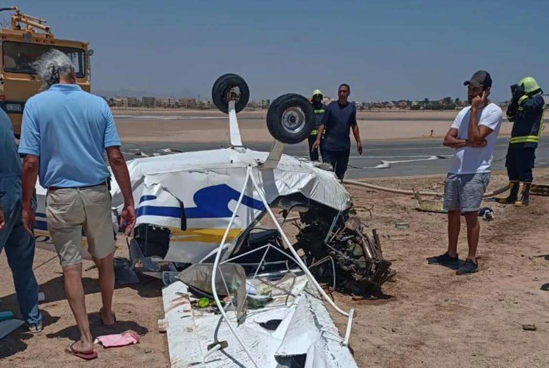 Egyptian investigators inspect a light aircraft which crashed on landing at Gouna airport, near Hurghada on the Red Sea coast, on August 6, 2020. (AFP)