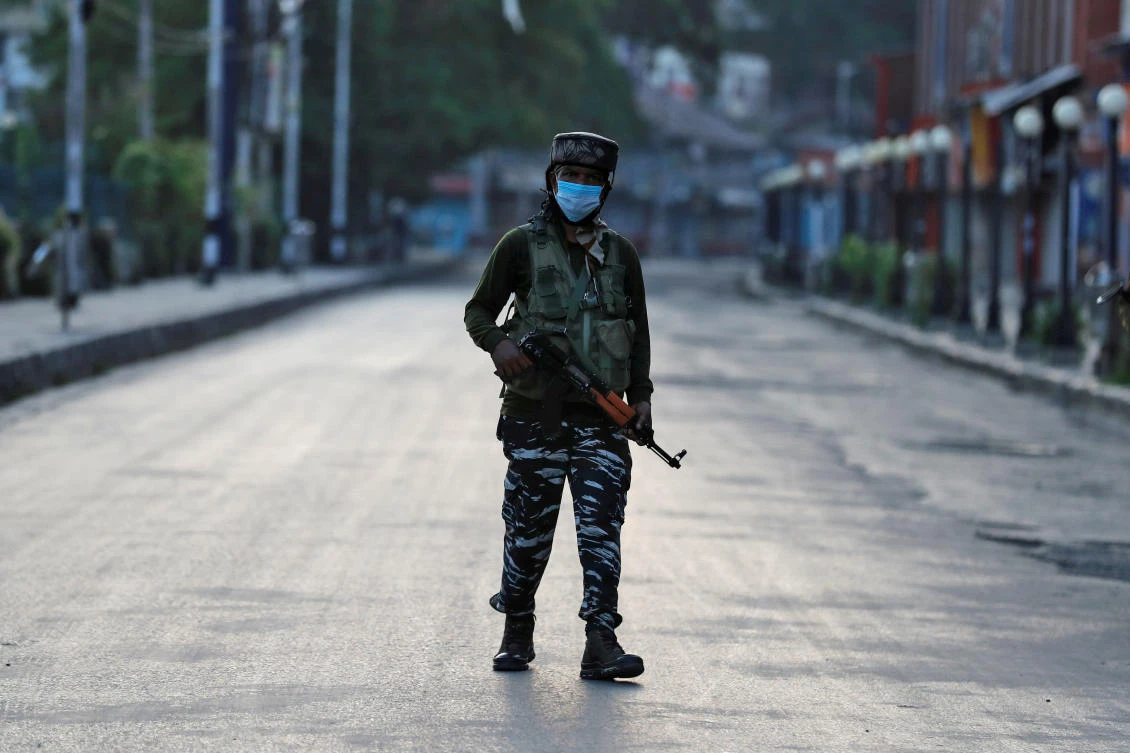 An Indian Central Reserve Police Force (CRPF) officer patrols on an empty street during a lockdown on the first anniversary of the revocation of Kashmir's autonomy, in Srinagar. (File/Reuters)