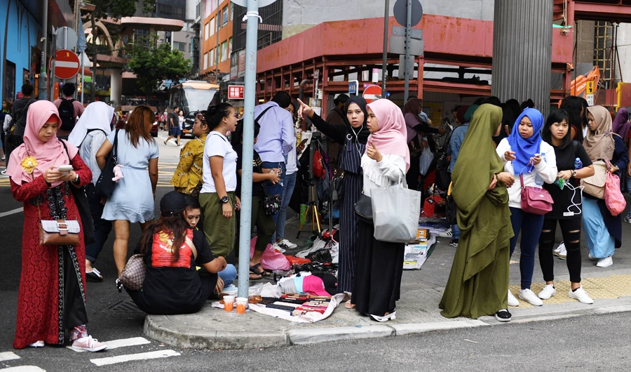 This picture taken on October 13, 2019 shows Indonesian migrant workers gathering near Victoria Park in Hong Kong. (AFP)