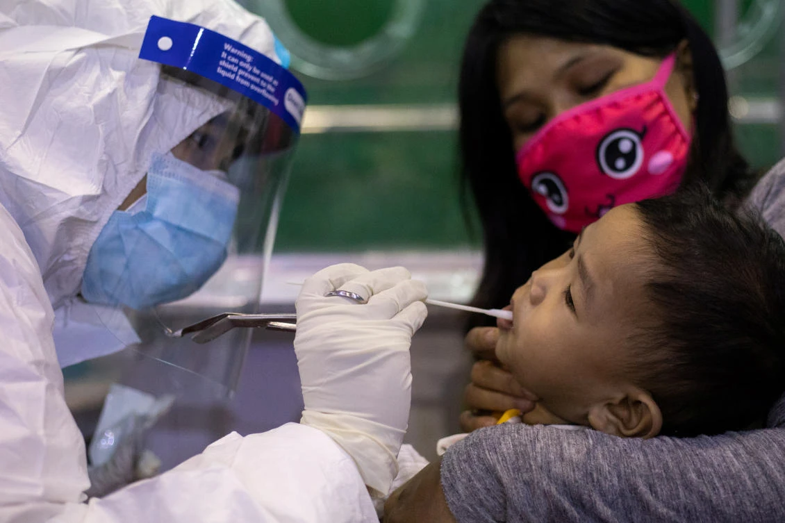 The Philippines leads Southeast Asian nations in the most number of cases. Above, a child receives free coronavirus testing in Navotas City on August 7, 2020. (Reuters)