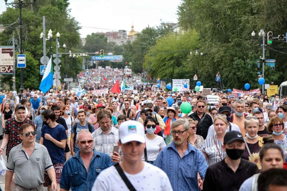 People hold banners and signs during an unauthorized rally in support of Sergei Furgal, the governor of the Khabarovsk region who was arrested, in the Russian far eastern city of Khabarovsk on July 25, 2020. (AFP)