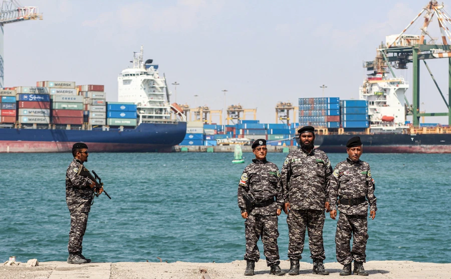 Yemeni members of the "Institution Protection Brigade" stand guard while on duty at the fishing port of Yemen's second city of Aden. (File/AFP)