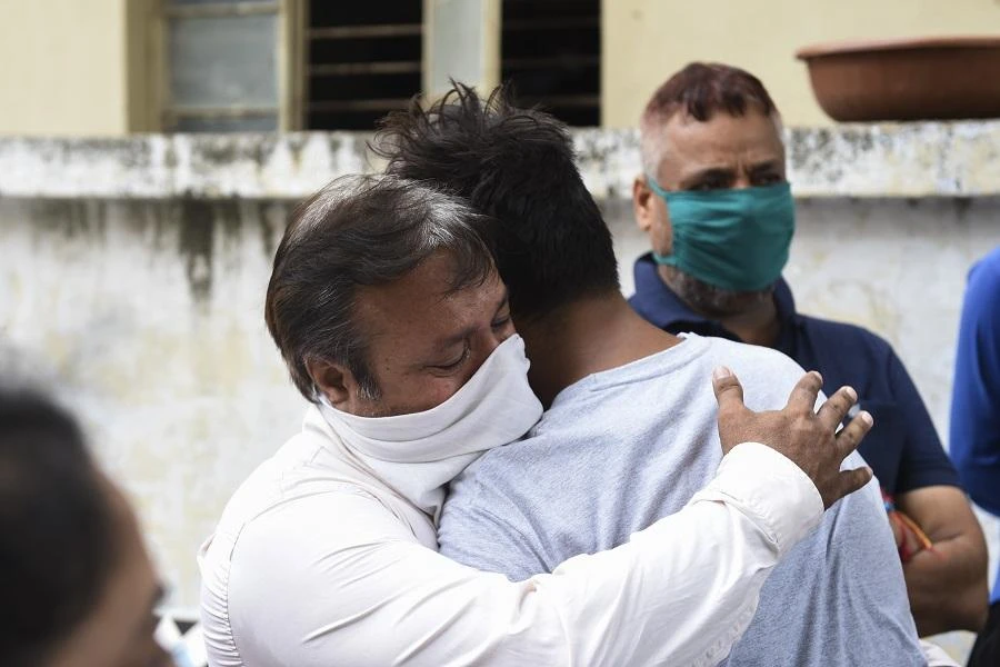 Relatives grief for their loved one outside the mortuary room of the Civil Hospital in Ahmedabad on August 6, 2020, after a fire broke early in the morning in the intensive care unit of the Shrey Hospital killing 8 coronavirus patients. (File/AFP)