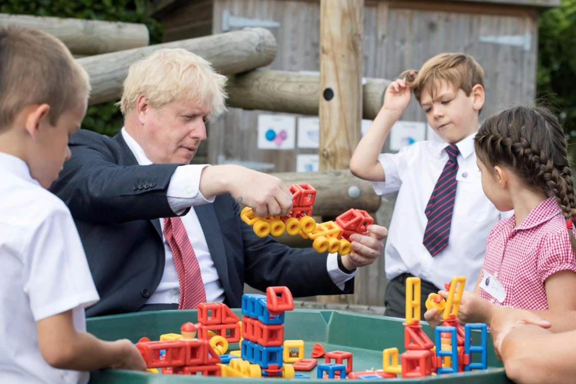 Britain's Prime Minister Boris Johnson plays with toys as students look on during a visit to The Discovery School in Kent, Britain. (File/Reuters)