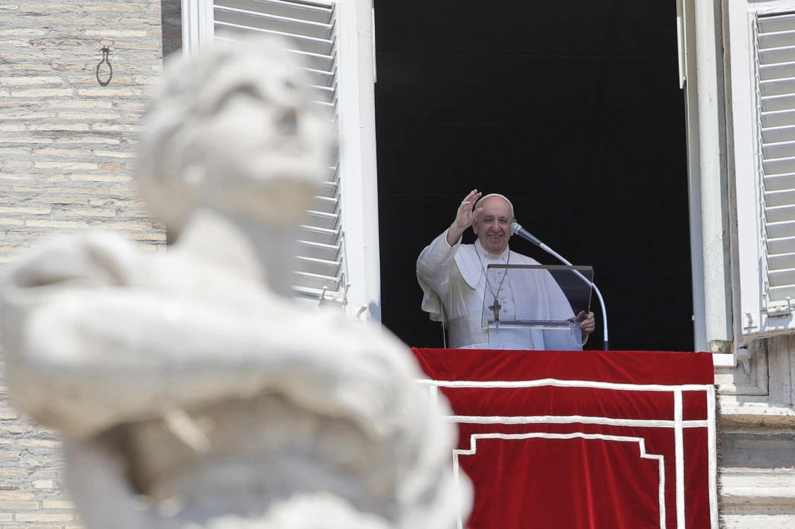 Pope Francis waves to faithful as he leaves after the Angelus noon prayer he delivered from the window of his studio overlooking St. Peter's Square at the Vatican, Sunday, Aug. 9, 2020. (AP)