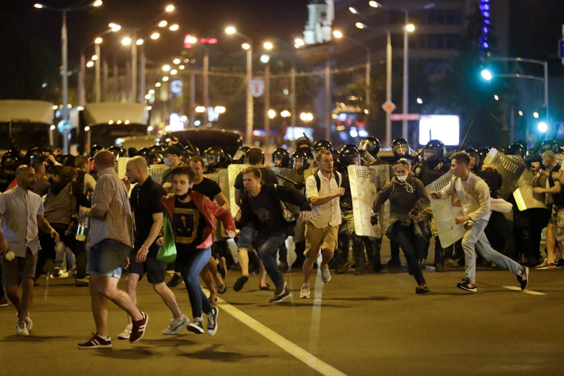 Demonstrators run away from police as they gather to protest against a result of the Belarusian presidential election in Minsk, Belarus, Sunday, Aug. 9, 2020. (AP)