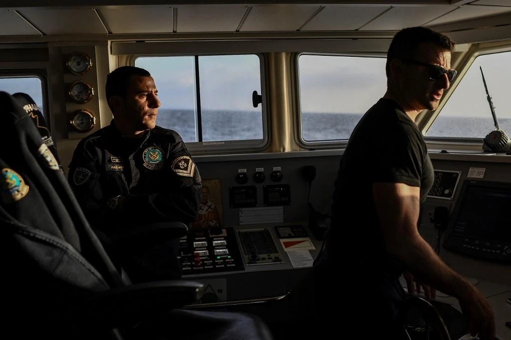 Above, Greek coast guard members patrol on a boat on the Mediterranean sea on March 19, 2019. (AFP)