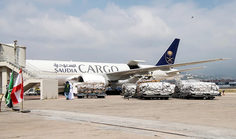 A staff member of King Salman Humanitarian Aid and Relief Center is seen next to humanitarian aid which has been unloaded at Beirut International airport to provide support following Tuesday's blast, Lebanon, August 7, 2020. (SPA via REUTERS)